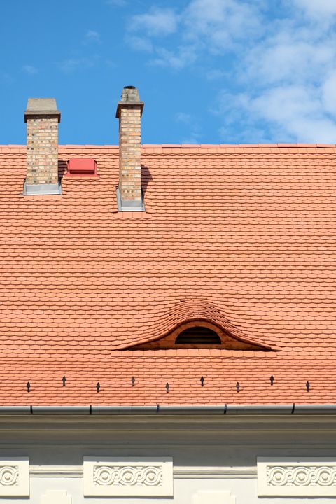 Eye shaped window in a tiled roof of Budapest