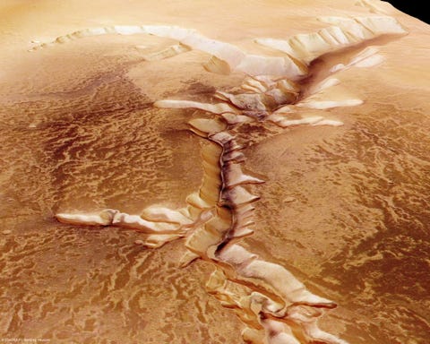 in the space July 16 in this handout provided by the european space agency esa on July 16, 2008, the echus chasma, one of the largest water source regions on mars, is depicted from esas mars express the data was obtained on september 25, 2005.  the dark material shows a network of light-colored, incised valleys similar to drainage networks known on earth.  It is still debated whether the valleys originated from precipitation, groundwater sources or liquid or magma flow on the surface.  Photo by esa via getty images