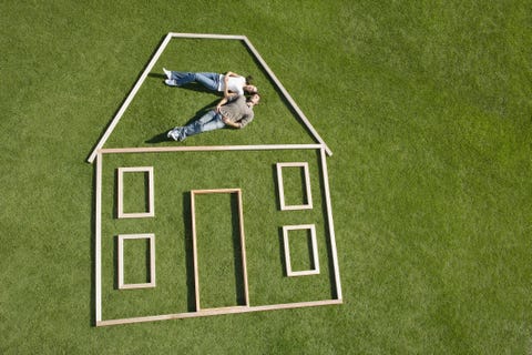 Cohabitation: Preparing to Take the Plunge couple lying on grass inside wooden house outline