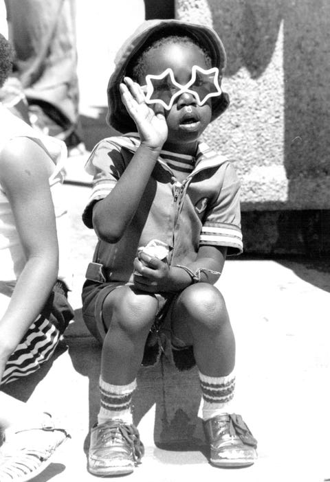 jun 18 1989, juneteenth celebration 24th and welson javhon walker age 3 waves at passing parade denver post via getty images