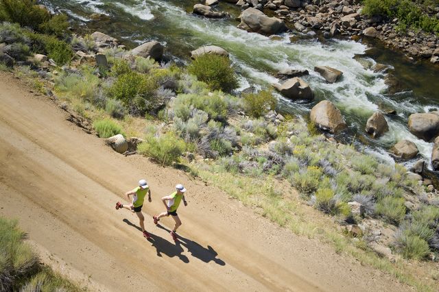 two men trail running in the rocky mountains