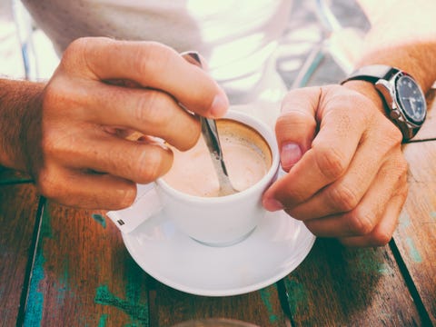 Hand stirring coffee