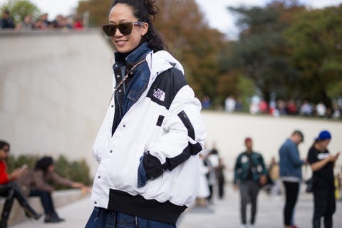 paris, france   october 02  a guest is seen attending hermes during paris fashion week wearing the north face on october 2, 2017 in paris, france  photo by matthew sperzelgetty images