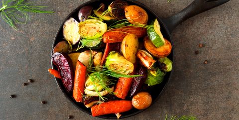skillet of roasted vegetables, above view on dark stone