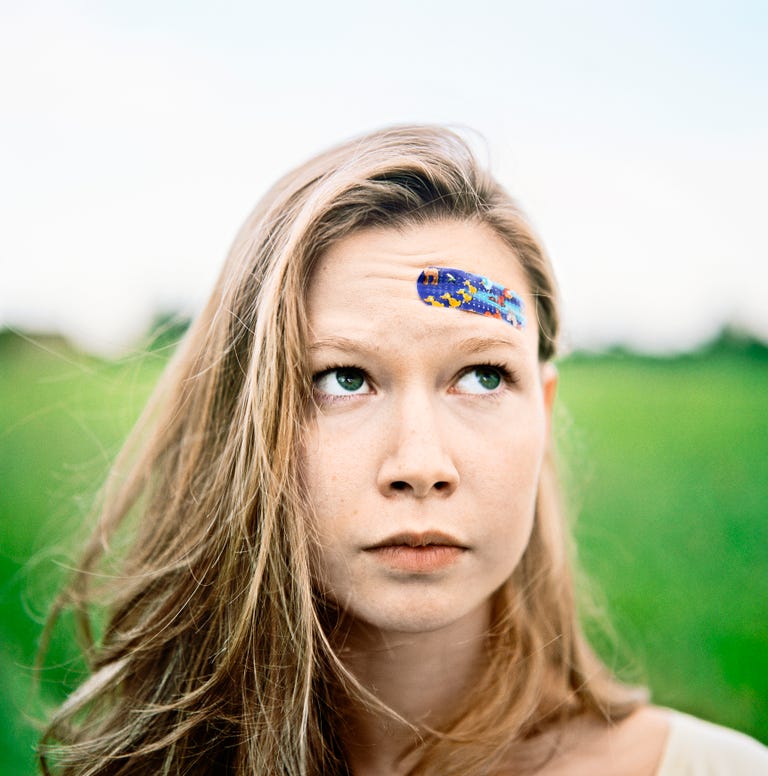 Young Woman With Band-Aid on Forehead