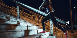 Young woman running at night in a urban city area