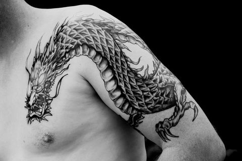 mans arm with a half sleeve chinese black dragon tattoo