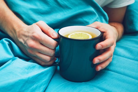 Sick man with hot tea in the bed