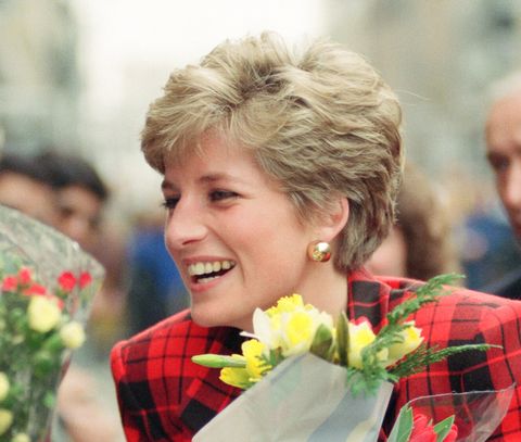 the princess of wales princess diana dressed in tartan on a walk in manchester where she visited the manchester art gallery in moseley street prince charles was also visiting but not pictured on this occasion the bodyguard ken wharfe stands behind princess in black jacket with green handkerchief in pocket photo taken 12 march 1991 photo by andrew stenningmirrorpixgetty images
