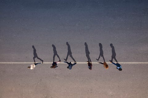 A group of young men, photographed from above, on various painted amphitheater surfaces, at sunrise