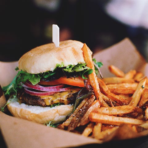 Close-Up Of Burger With French Fries On Table Close-Up Of Burger With French Fries On Table