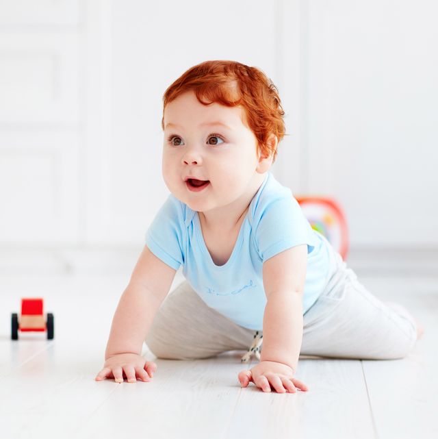 cute infant baby crawling on the floor at home