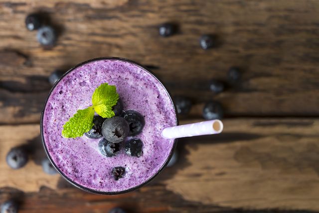 blueberry smoothies juice and blueberry fruit  from the wood background from the top view