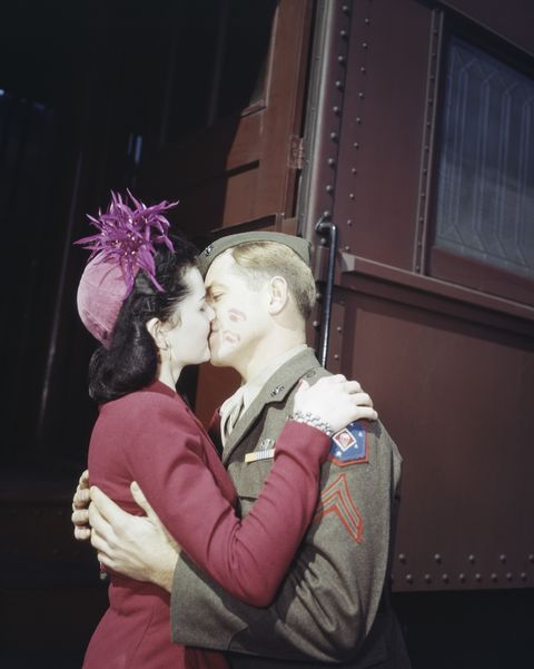 soldier kissing his wife before leaving