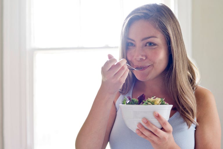 keto diet side effects - woman eating salad keto diet side effects - woman eating salad