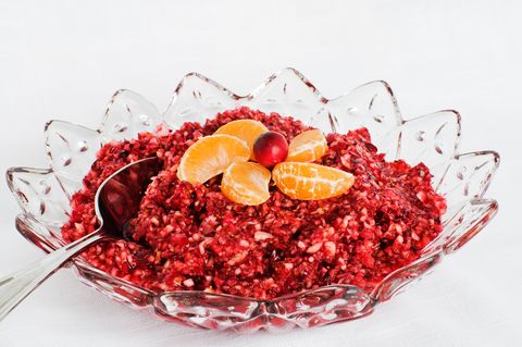 Fancy glass bowl of cranberry sauce with other fruit on top