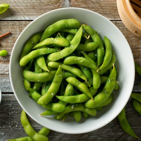 fresh steamed edamame sprinkled with sea salt on a rustic tabletop