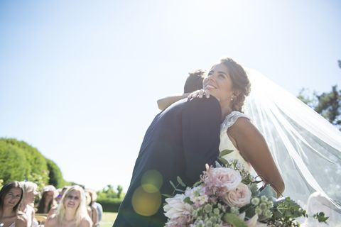 A bride and groom embrace on their wedding day