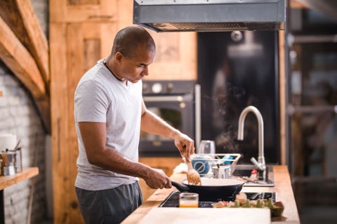 man cooking in home kitchen