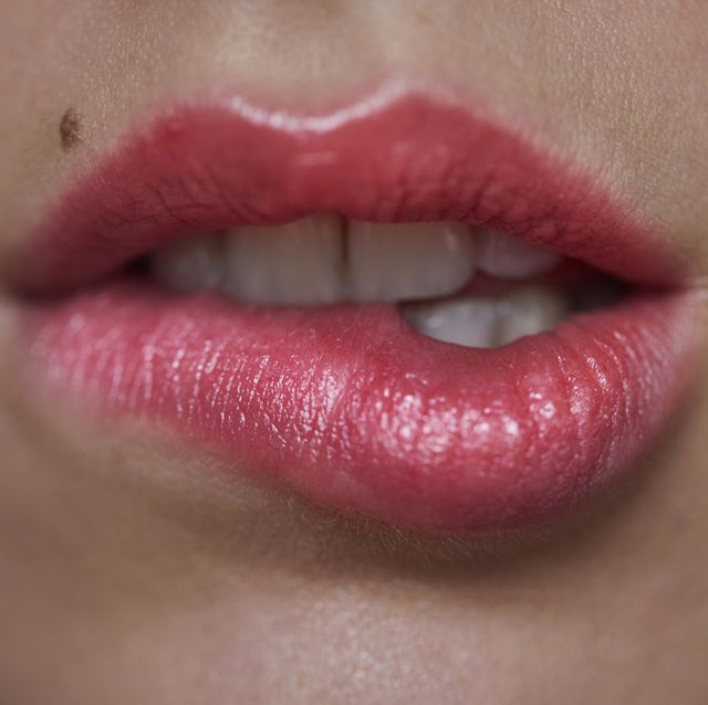 Close-up of woman biting on her lip