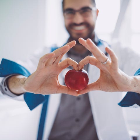 Holding a red apple holding a red apple