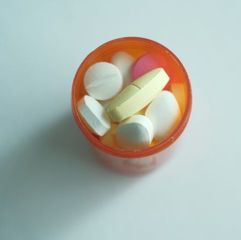 close up of multi color medicine and pills on white background