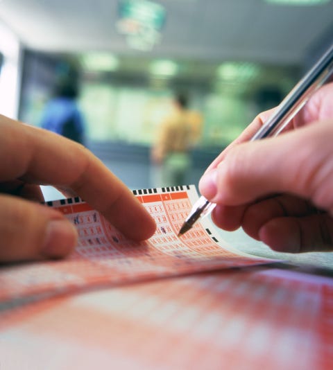 Man's hands marking numbers on lottery ticket, close-up lottery tickets