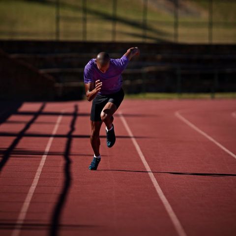 man running on athletics track