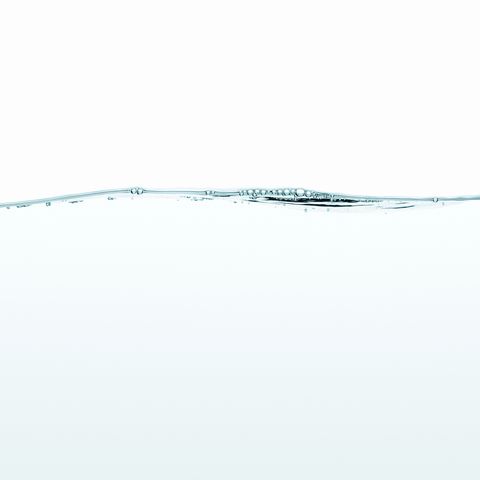 Water, studio shot on white background, surface level