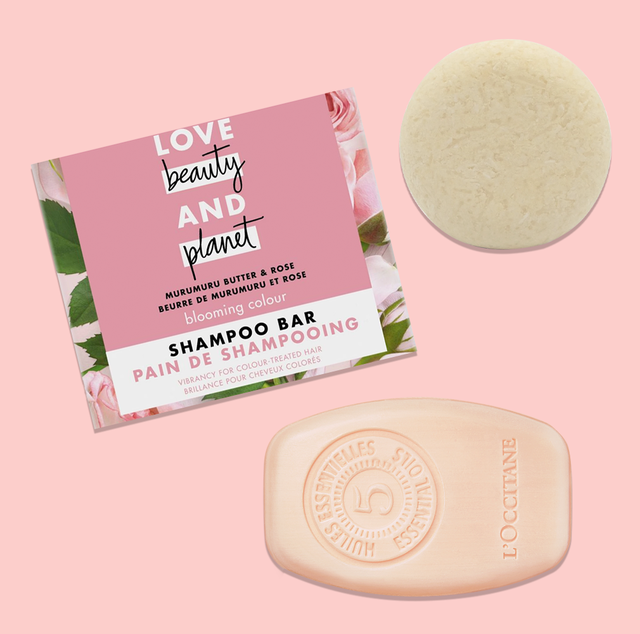 some of good housekeeping's best shampoo bars, a box of love beauty and planet shampoo bar, a l'occitane shampoo bar, and a good juju shampoo bar on a pink background