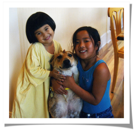 two girls with adopted dog