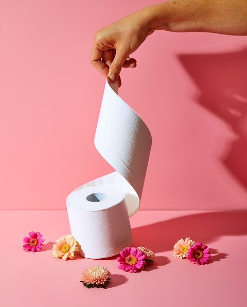 Toilet paper with flowers on a pink background