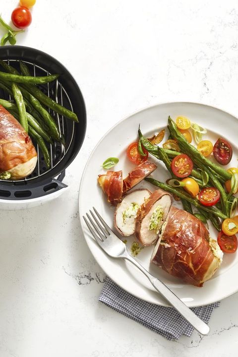 air fryer stuffed chicken with green beans on white plate