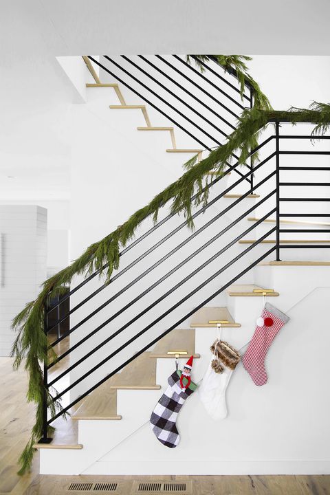 staircase with garland and christmas stockings