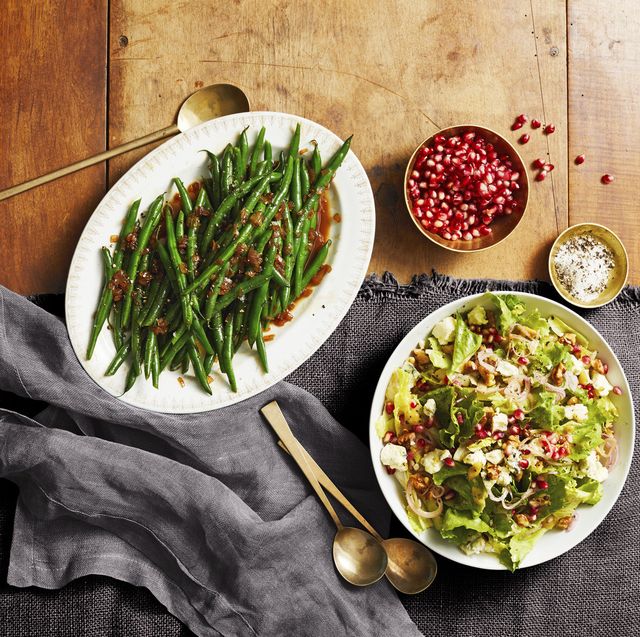 escarole salad with red wine vinaigrette, sherry glazed green beans, and a small bowl of pomegranate seeds
