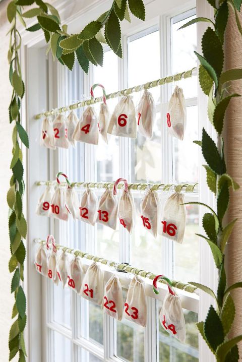 advent calendar in window with bags handing from adjustable curtain rods