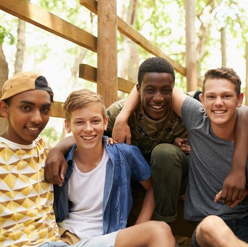shot of a group of teen boys hanging out together outside
