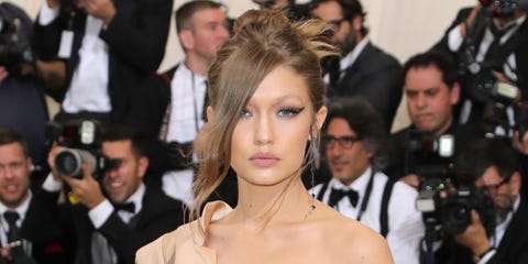 Gigi Hadid Walks The 17 Met Gala Red Carpet In Tommy Hilfiger Dress