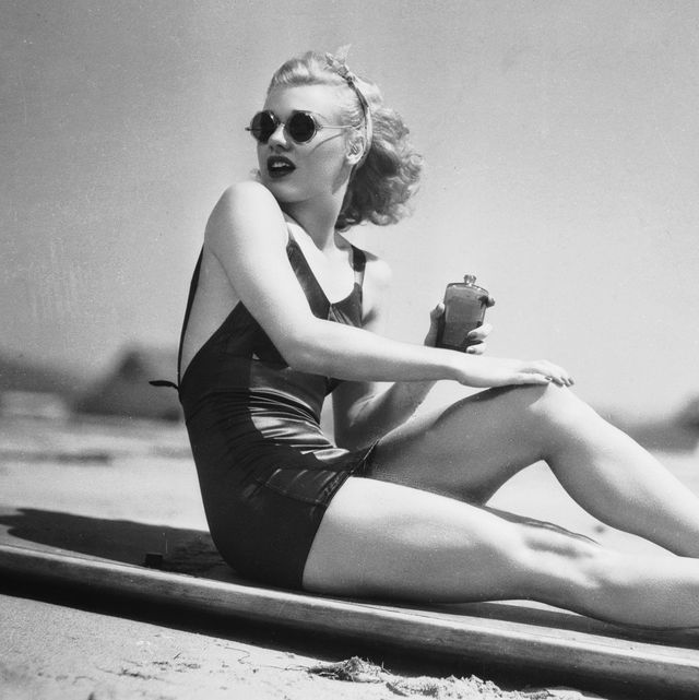1936  legendary american dancer and actress ginger rogers 1911   1995 rubs sun lotion onto her legs before a stint of sunbathing  photo via john kobal foundationgetty images