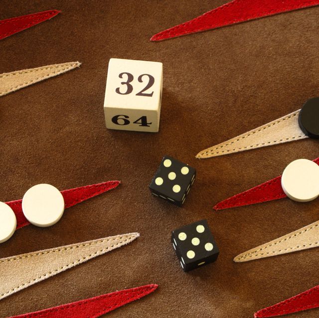 doubling cube during backgammon game, with the numerals 2, 4, 8, 16, 32, and 64 on its faces, is used to keep track of the current stake of the game