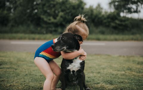 Girl hugs Dog