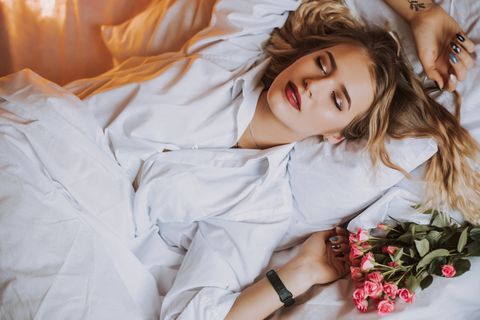girl on the white bed with flowers