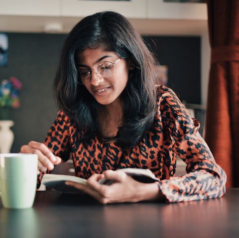 hobbies for women - Girl reading book with a coffe mug