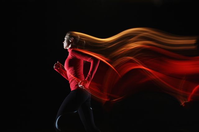 girl running and leaving light streaks