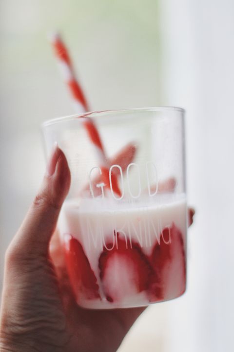 girls holding a cup of strawberry yogurt