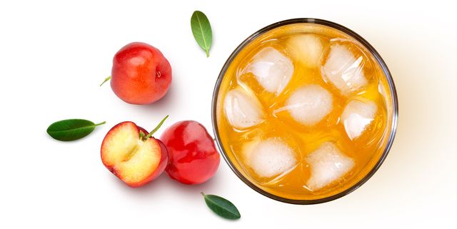 glass of acerola juice and acerola cherry