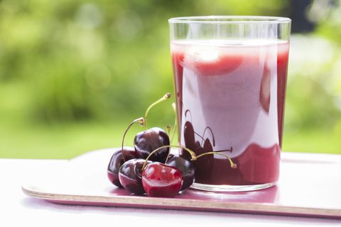 Glass of Cold cherry  juice in garden