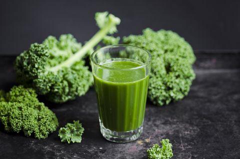 Glass of kale smoothie with different fruits
