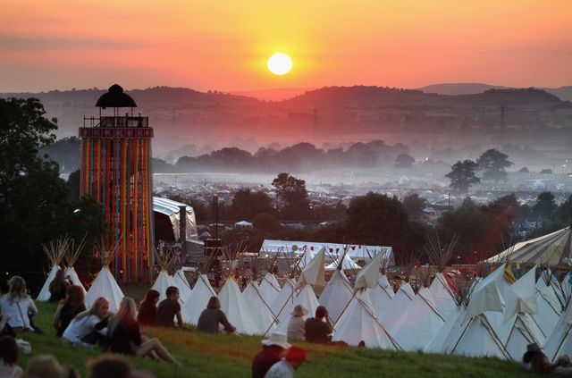 glastonbury, united kingdom   june 24  people gather to watch the sunset on a hill above the tipi field as music fans start to arrive at the glastonbury festival site at worthy farm, pilton on june 24, 2009 in glastonbury, somerset, england the gates have opened for the first of the 140000 music fans arriving, at what has become one of europes largest music festivals, but weather forecasters have warned that bad weather may be on the way  photo by matt cardygetty images