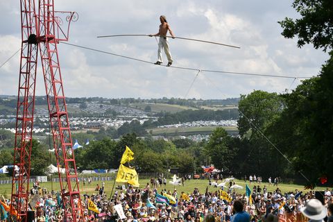 A tight rope walker performs at Stone Circle Field after the Peace Procession on the second day of Glastonbury Festival 2023 in Glastonbury, England on June 22, 2023. Worthy Farm, Pilton in Glastonbury, England Photo by Jim Dishonredferns